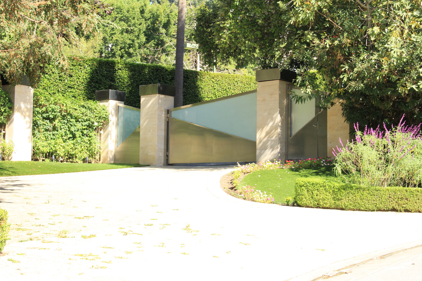 contemporary steel and glass folding electric gate and hinged pedestrian gate Los Angeles